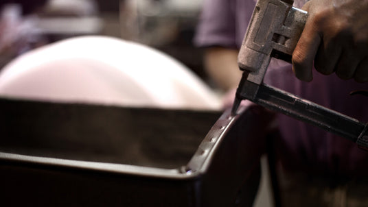 Close-up of Jansen piano bench being hand-upholstered in American workshop