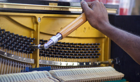 Tuning an upright piano with hardwood piano tuning lever