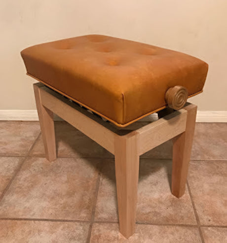 Jansen petite artist bench with caramel vinyl upholstery in natural wood finish