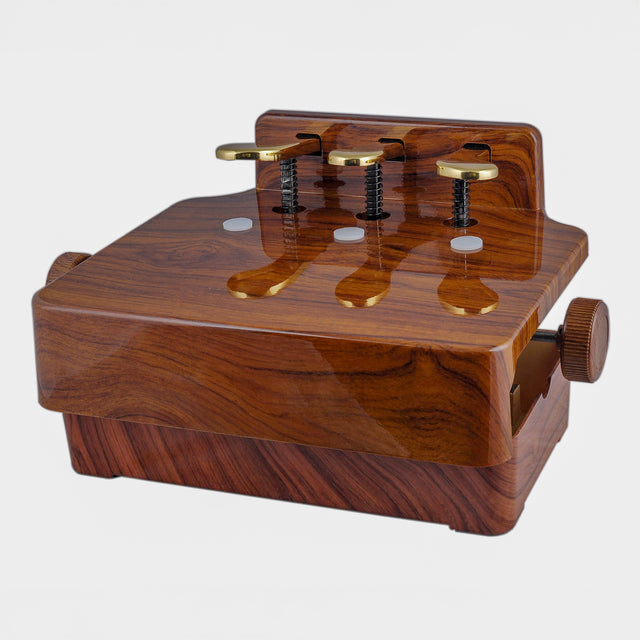 Children's piano pedal extender with 3 pedals in a brown walnut finish
